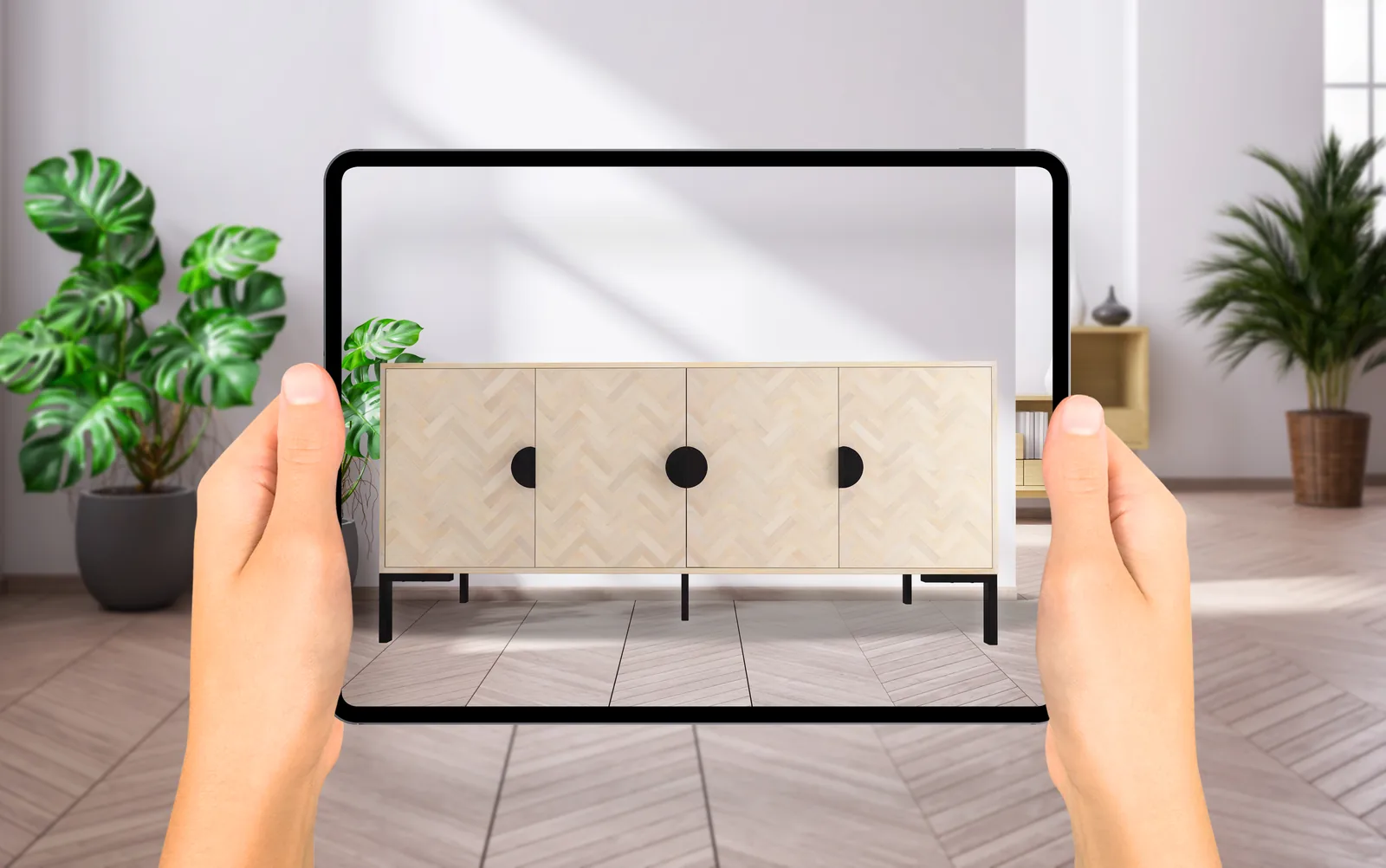 A shopper placing a sideboard in their room with AR on a tablet